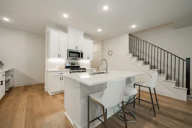 a large white kitchen with a large window
