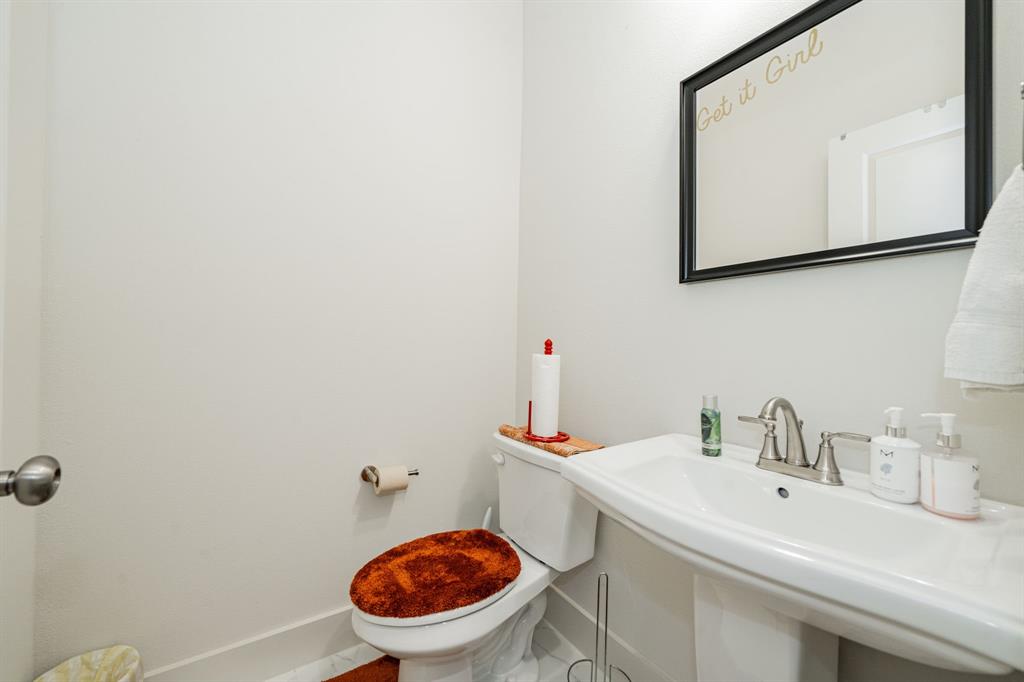 1416 Solterra Boulevard Mesquite, TX 75181 - Photo 19 of 32 a bathroom with a sink and a toilet
