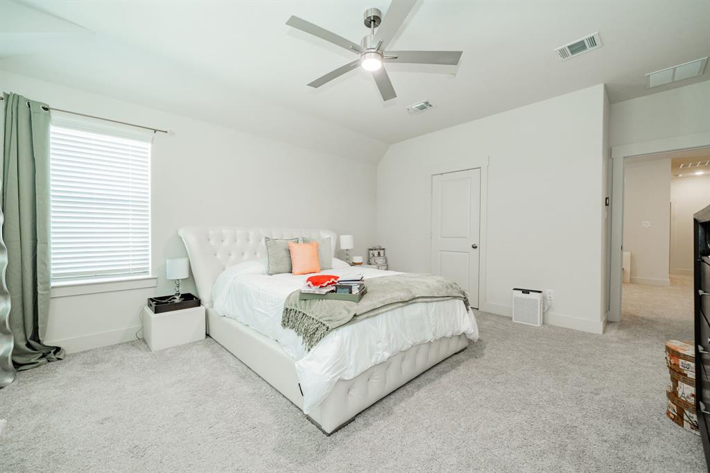 1416 Solterra Boulevard Mesquite, TX 75181 - Photo 21 of 32 a bedroom with a bed and a ceiling fan