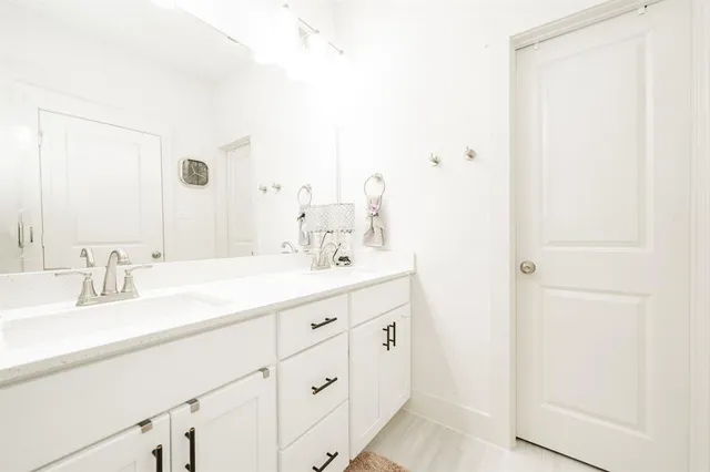 a bathroom with a double vanity sink and mirror