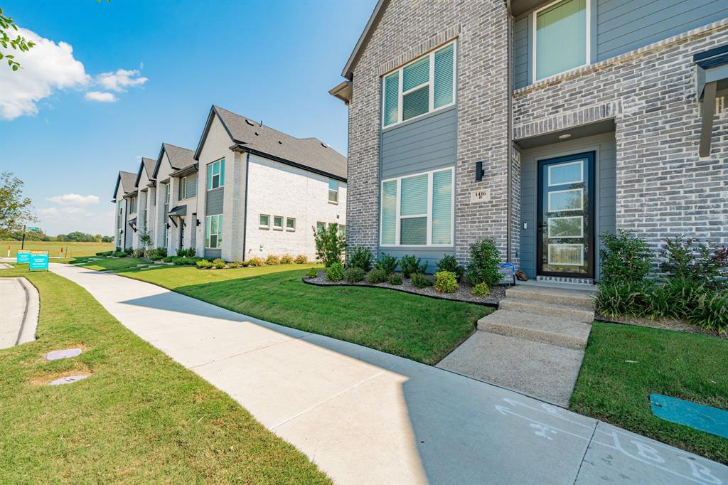 1416 Solterra Boulevard Mesquite, TX 75181 - Photo 3 of 32 a front view of a house with a yard and garage
