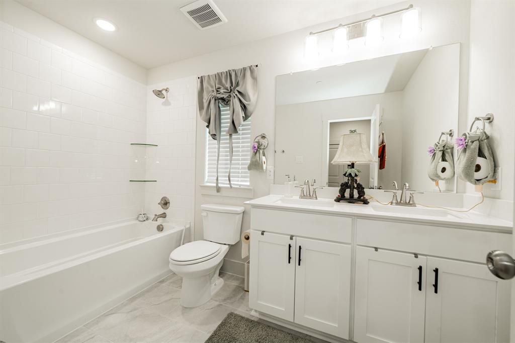1416 Solterra Boulevard Mesquite, TX 75181 - Photo 30 of 32 a bathroom with a sink a toilet and shower