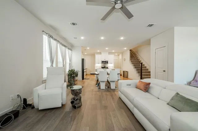 a living room with furniture and a wooden floor