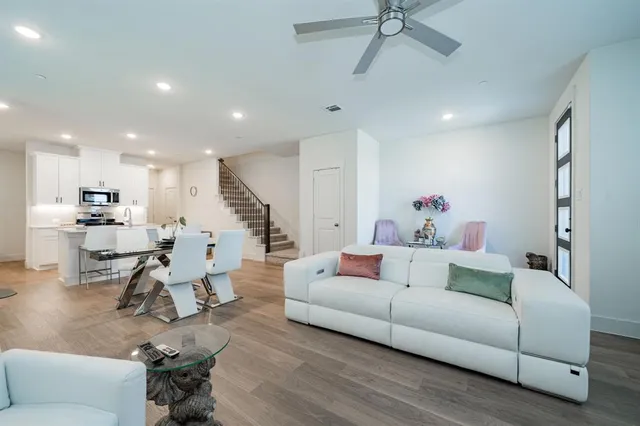a living room with furniture and wooden floor