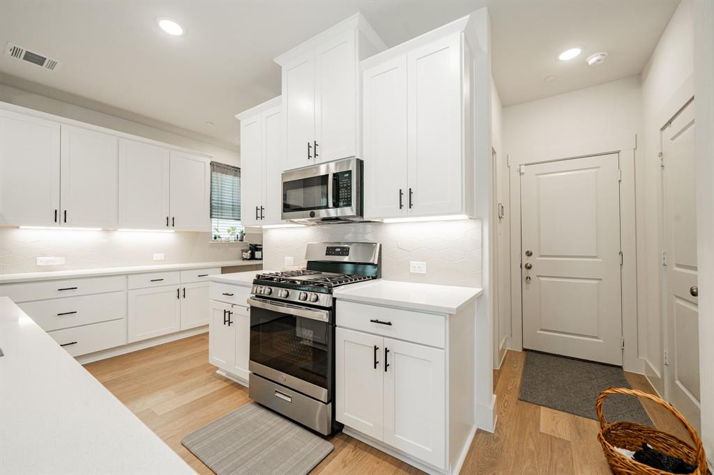 1416 Solterra Boulevard Mesquite, TX 75181 - Photo 10 of 32 a kitchen with cabinets stainless steel appliances and sink