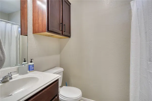 a bathroom with a sink a toilet and mirror