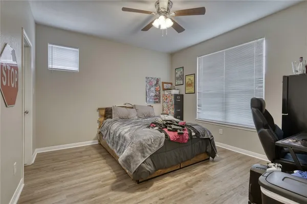 a bedroom with a bed and wooden floor