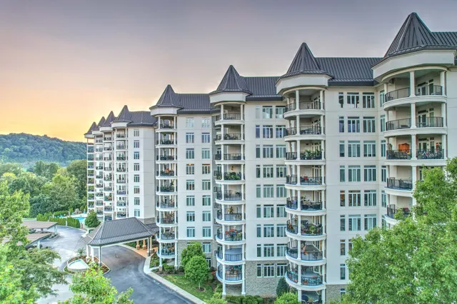a view of a swimming pool with a patio and a garden