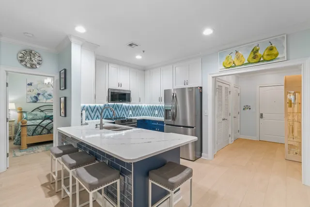 a living room with patio furniture and a flat screen tv