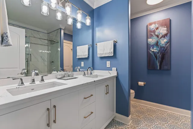 a bed room with a bed and a chandelier