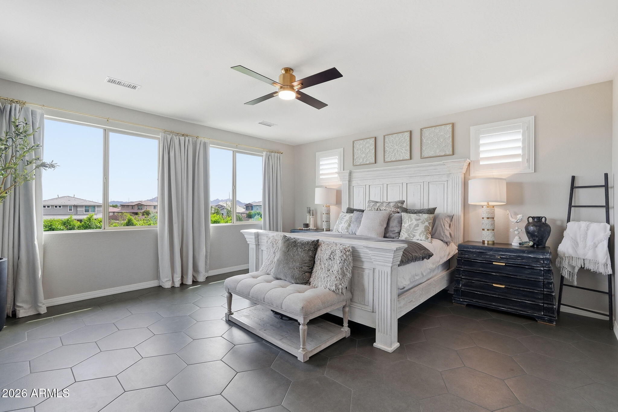 22607 East Russet Road Queen Creek, AZ 85142 - Photo 25 of 64 a spacious bedroom with a bed and a window