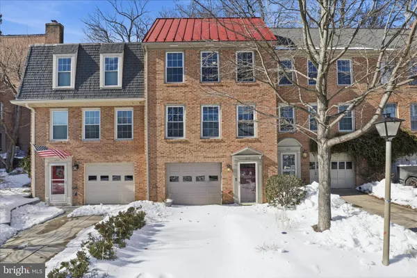 a front view of a building with a yard covered in snow
