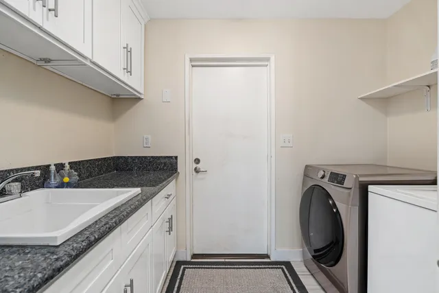a utility room with a sink a washer and dryer
