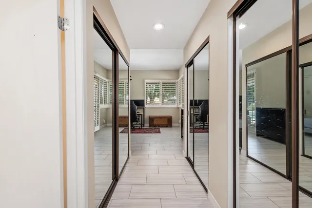 a hallway with a dining table and chairs