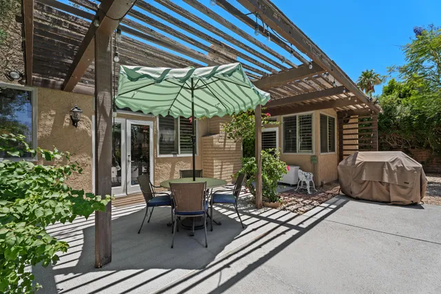 a view of a house with backyard sitting area and porch