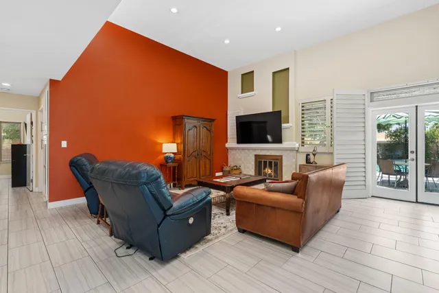 a living room with fireplace furniture and a flat screen tv