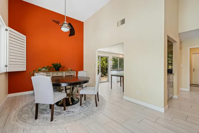 a view of a dining room with furniture and a window