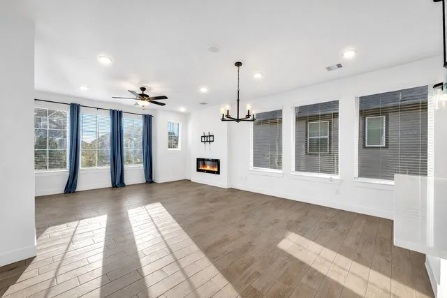 a kitchen with stainless steel appliances kitchen island a sink a stove a refrigerator and white cabinets