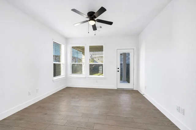 a view of a hallway with wooden floor and staircase