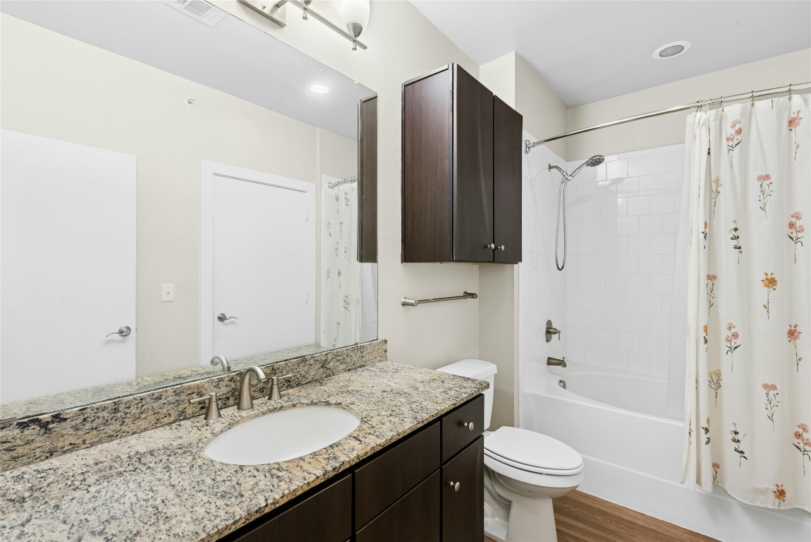 1900 Barton Springs Road, Unit 4004 Austin, TX 78704 - Photo 12 of 19 a bathroom with a granite countertop sink toilet and shower