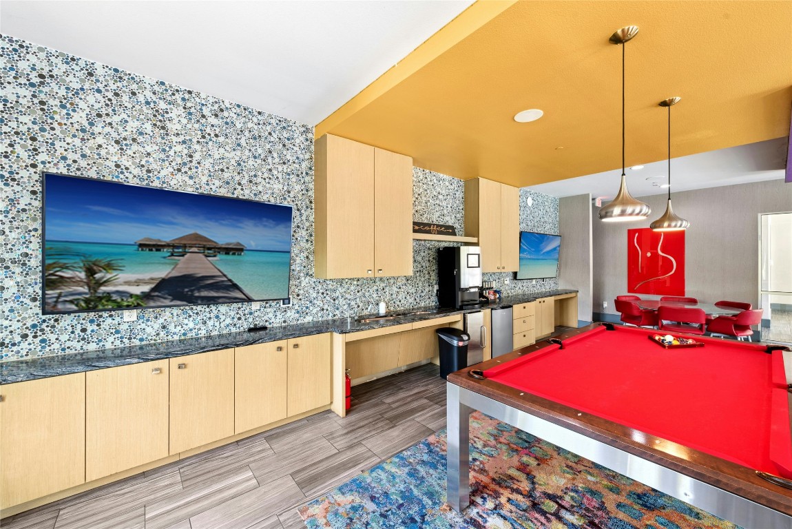 1900 Barton Springs Road, Unit 4004 Austin, TX 78704 - Photo 18 of 19 a kitchen with sink a stove and chairs