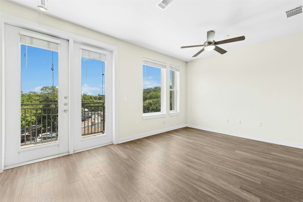1900 Barton Springs Road, Unit 4004 Austin, TX 78704 - Photo 4 of 19 a view of an empty room with wooden floor and a window