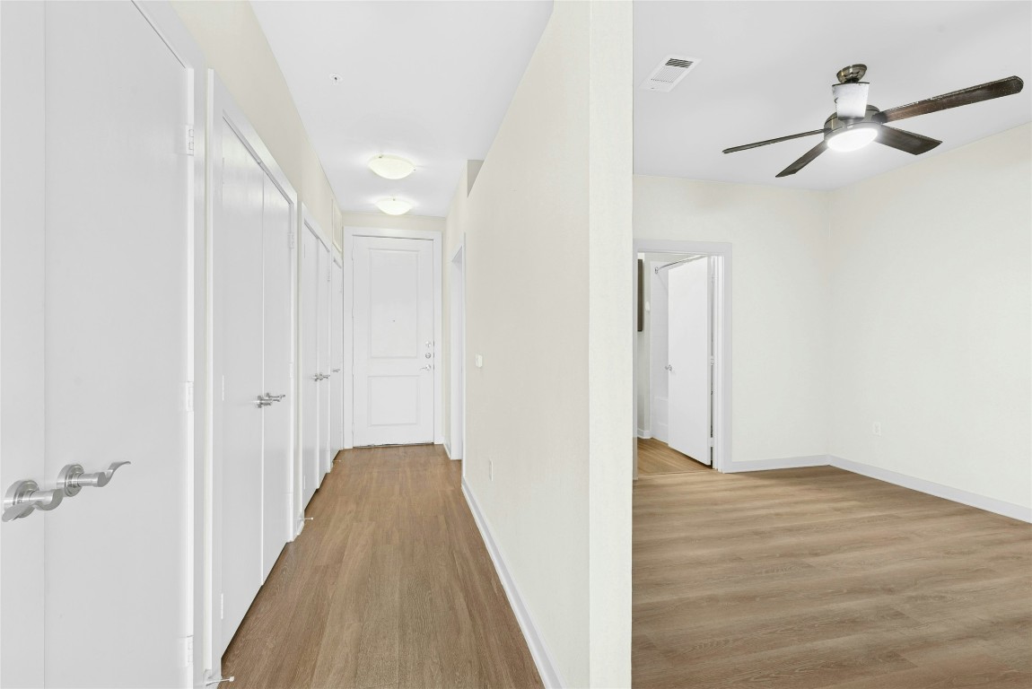 1900 Barton Springs Road, Unit 4004 Austin, TX 78704 - Photo 8 of 19 a view of a hallway with wooden floor and staircase