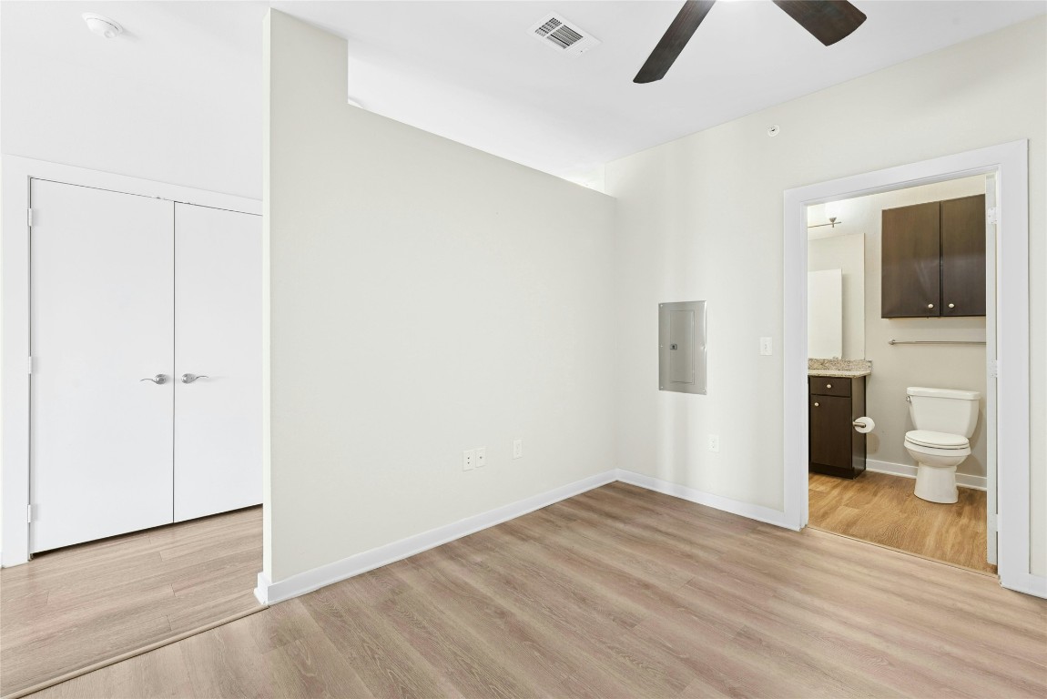 1900 Barton Springs Road, Unit 4004 Austin, TX 78704 - Photo 10 of 19 a view of a livingroom with wooden floor and a ceiling fan