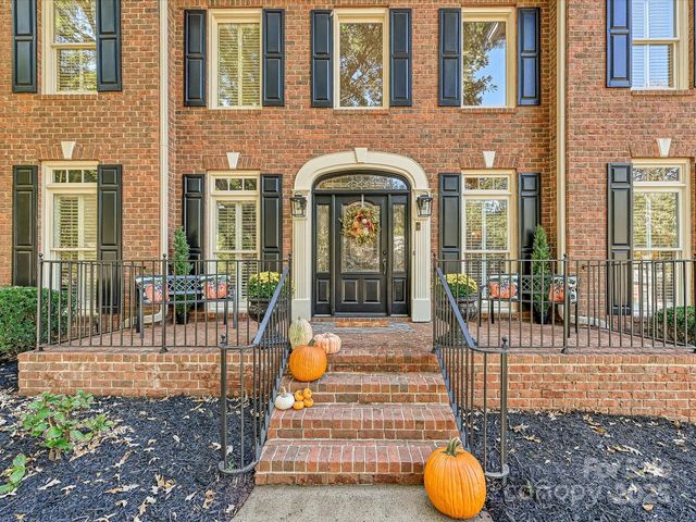 a view of a brick house with many windows