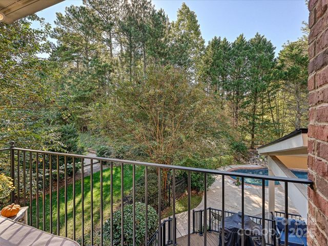 a view of a balcony with wooden floor and fence