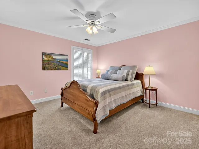 a spacious bedroom with a bed and a chandelier