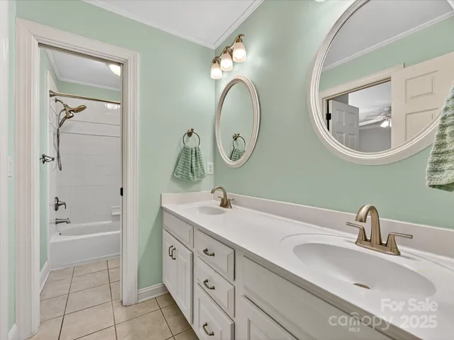 a bathroom with 2 sink tub and a mirror