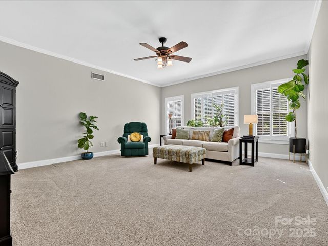 a bedroom with furniture and a ceiling fan
