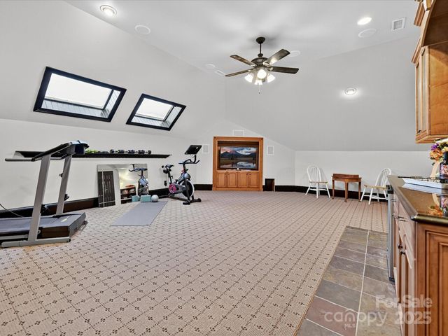 a view of a livingroom with furniture and a gym machine