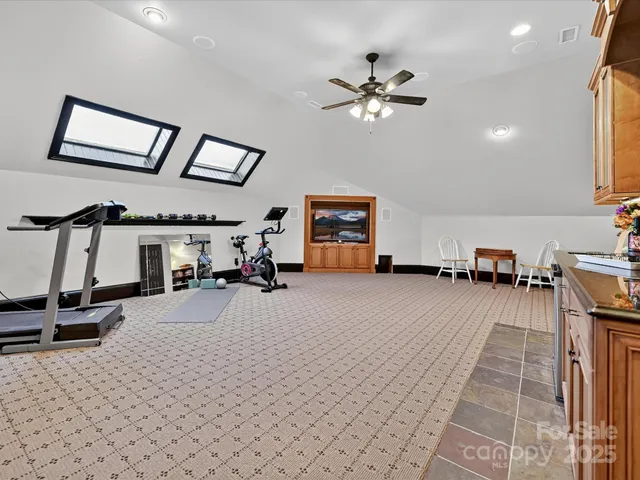 a view of a livingroom with furniture and a gym machine