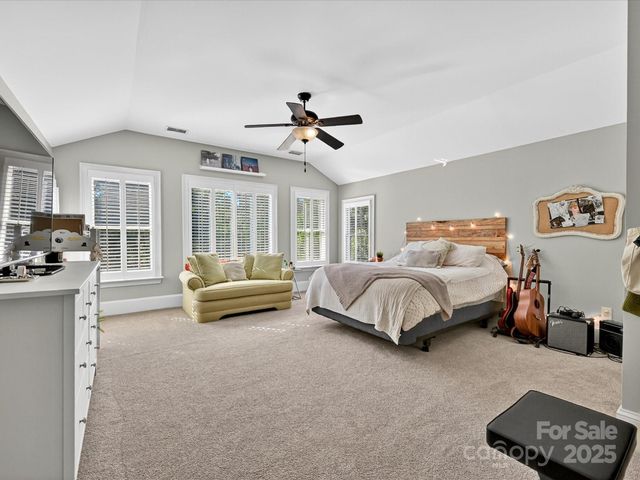 a bedroom with a bed couch and a window