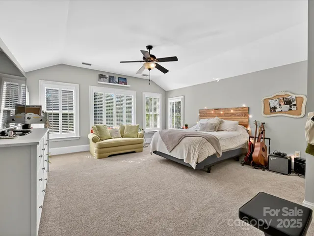 a bedroom with a bed couch and a window