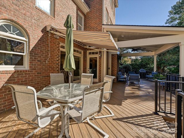 a view of a patio with table and chairs and potted plants
