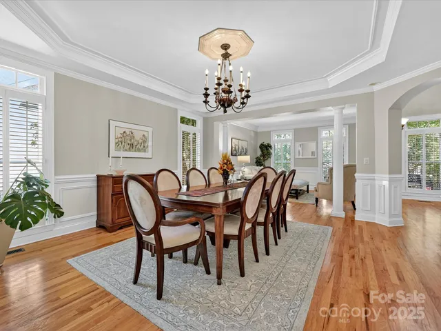 a view of a a dining room with furniture window and wooden floor