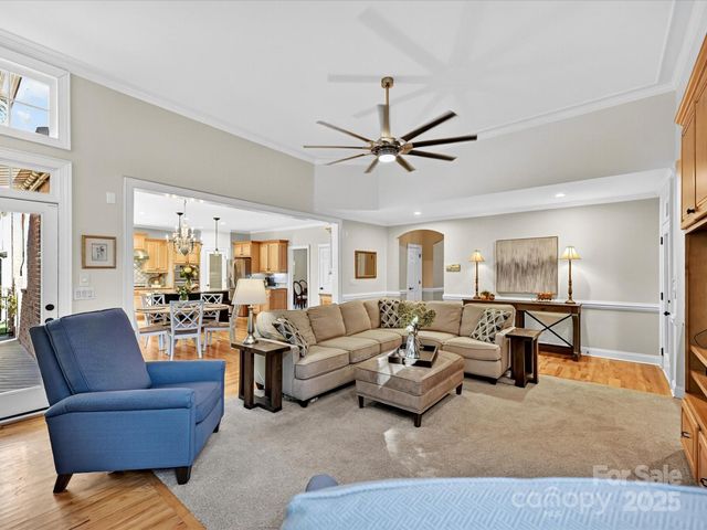 a living room with furniture ceiling fan and a rug