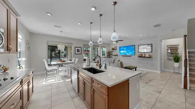 a kitchen with stainless steel appliances granite countertop sink stove and refrigerator