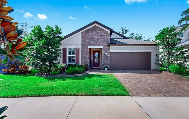 a front view of house with yard and green space