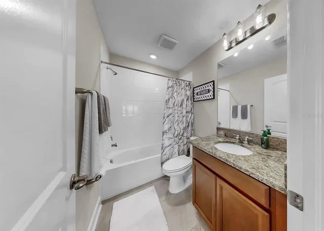 an aerial view of a house with a garden and trees