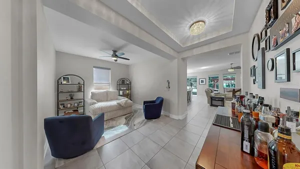 a kitchen with a refrigerator a sink and chairs