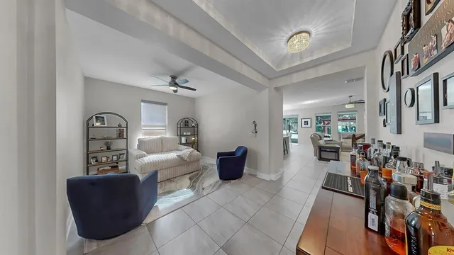 a kitchen with a refrigerator a sink and chairs