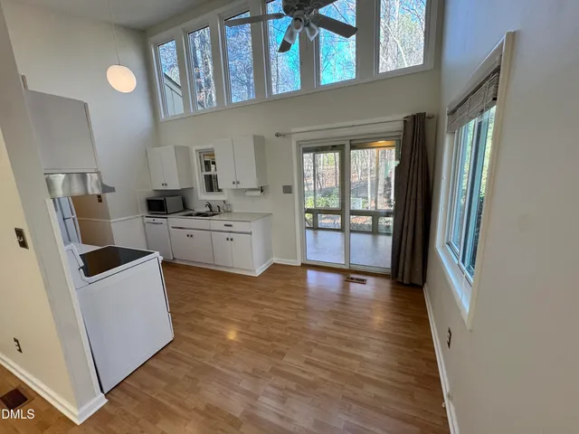 a kitchen with stainless steel appliances a stove top oven a sink a refrigerator and cabinets