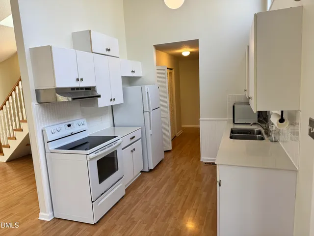 a kitchen with a stove a sink and a refrigerator