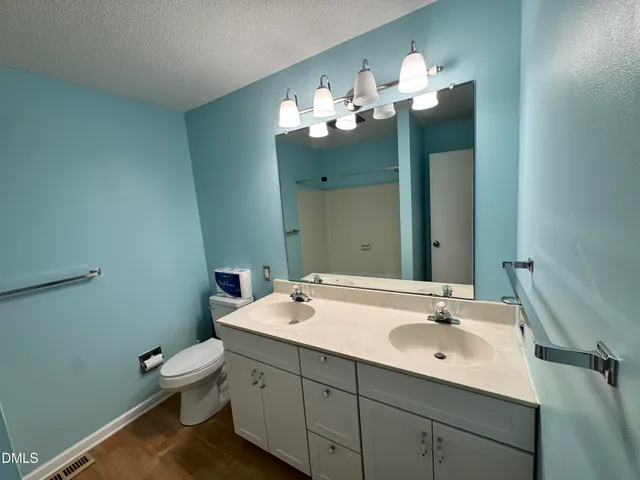a bathroom with a sink double vanity and a mirror