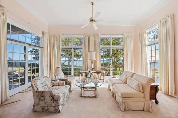 a bedroom with furniture and a large window