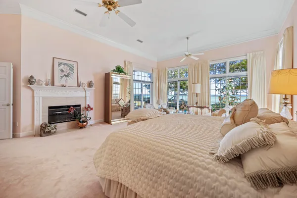 a bedroom with a bed mirror and a window